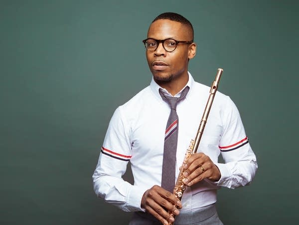 a man posing with a flute
