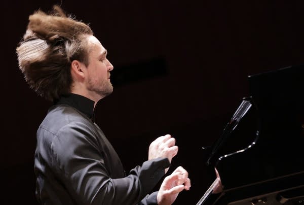 A pianist's hair flies during an impassioned performance