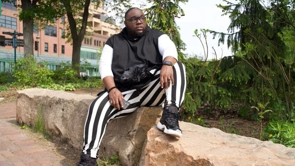 Director Courtland Pickens sitting on stone